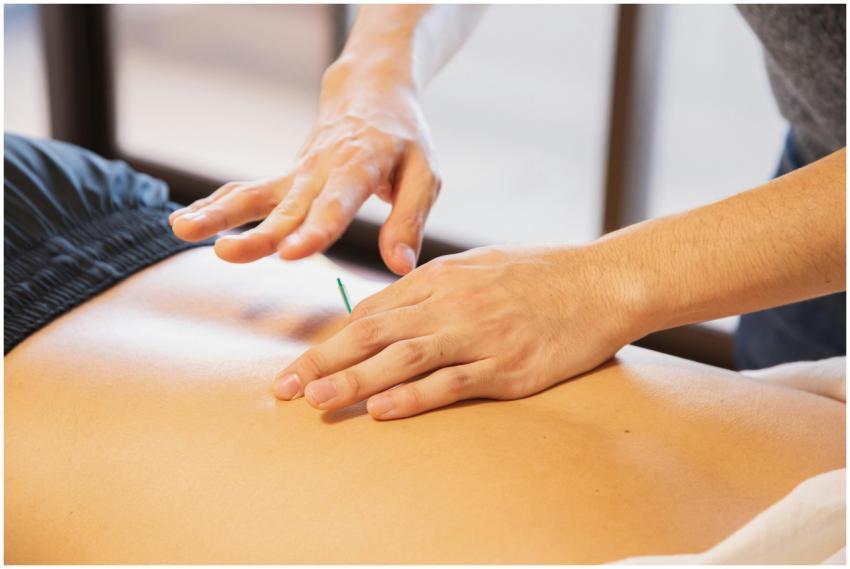 Crop anonymous male doctor putting needles on back