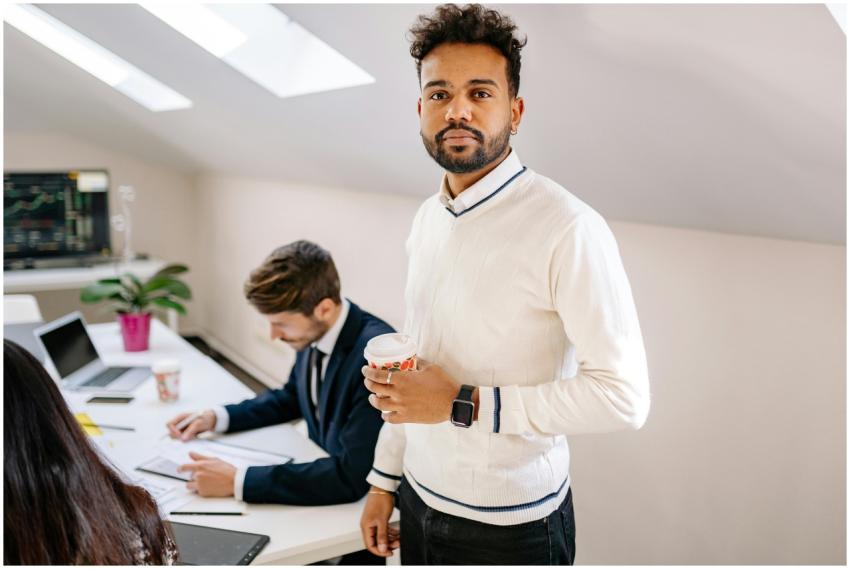 Confident businessman with coffee in a modern offi
