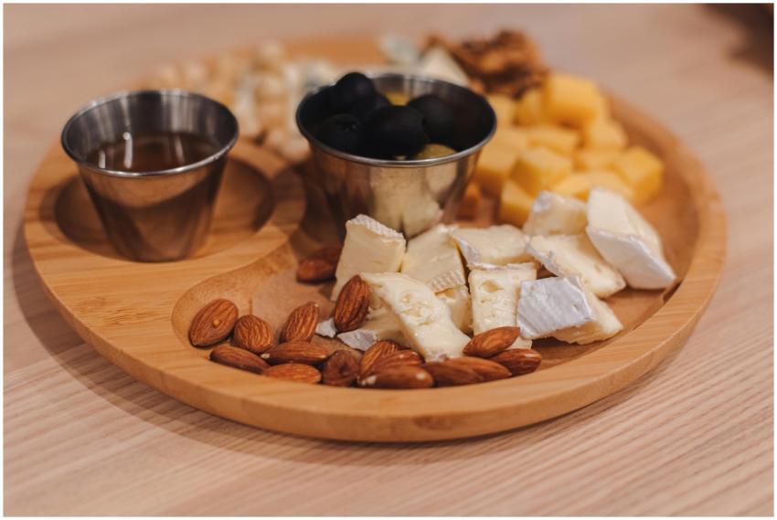 A close-up of a wooden tray featuring assorted che