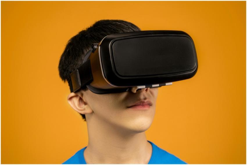 Young man immersed in virtual reality using VR hea