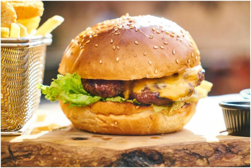 Juicy cheeseburger with crispy fries served on a w