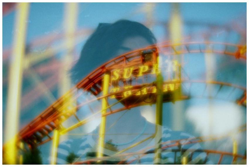 Creative double exposure of a roller coaster and p