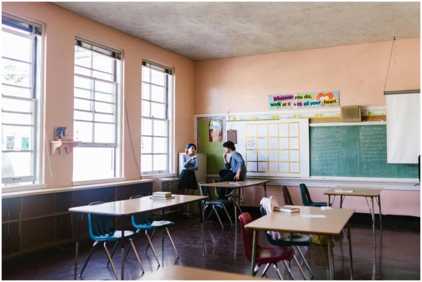 Two students having a conversation in a quiet clas