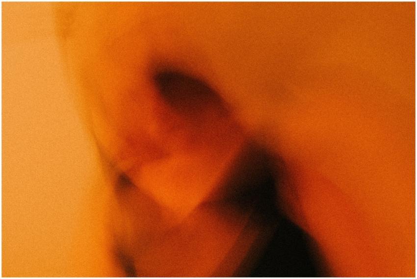 Dynamic blurred image with warm orange tones and a