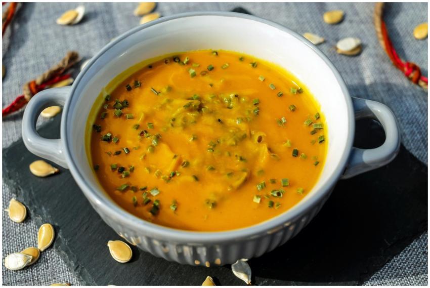 Warm and creamy pumpkin soup garnished with fresh