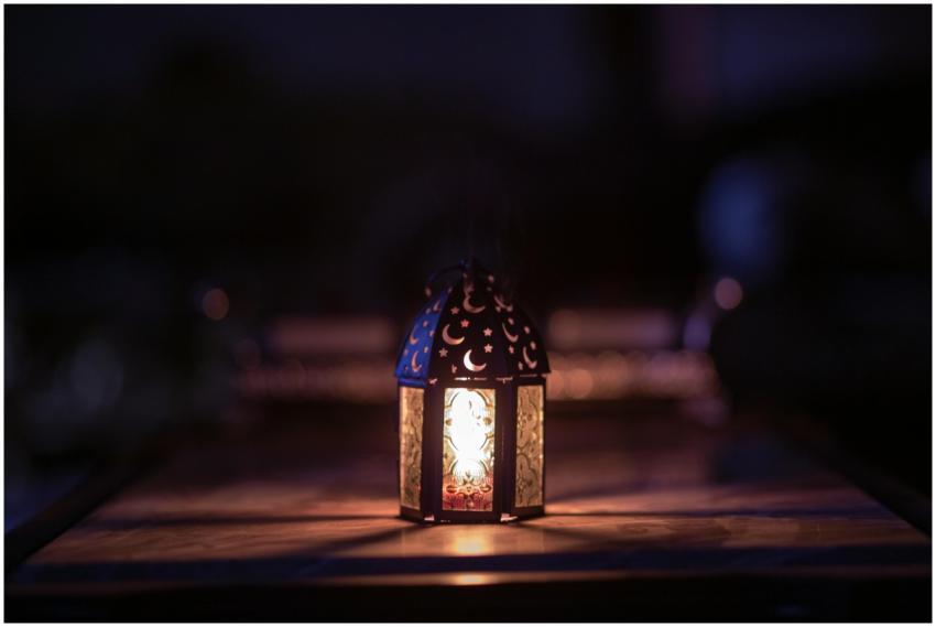 A beautifully decorated lantern illuminates a dark