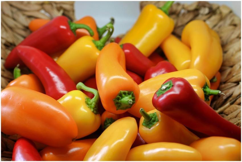 Colorful bell peppers in a woven basket, showcasin
