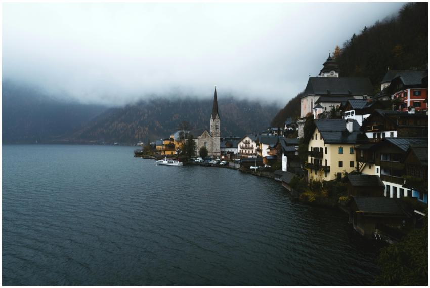 A serene, foggy morning in Hallstatt, Austria, sho