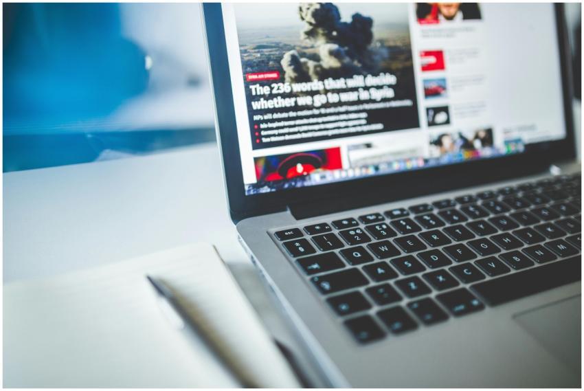 Open laptop displaying an online news article on a