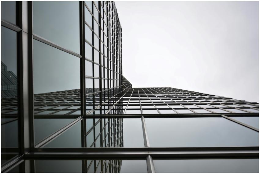 Low angle view of a modern glass skyscraper with r