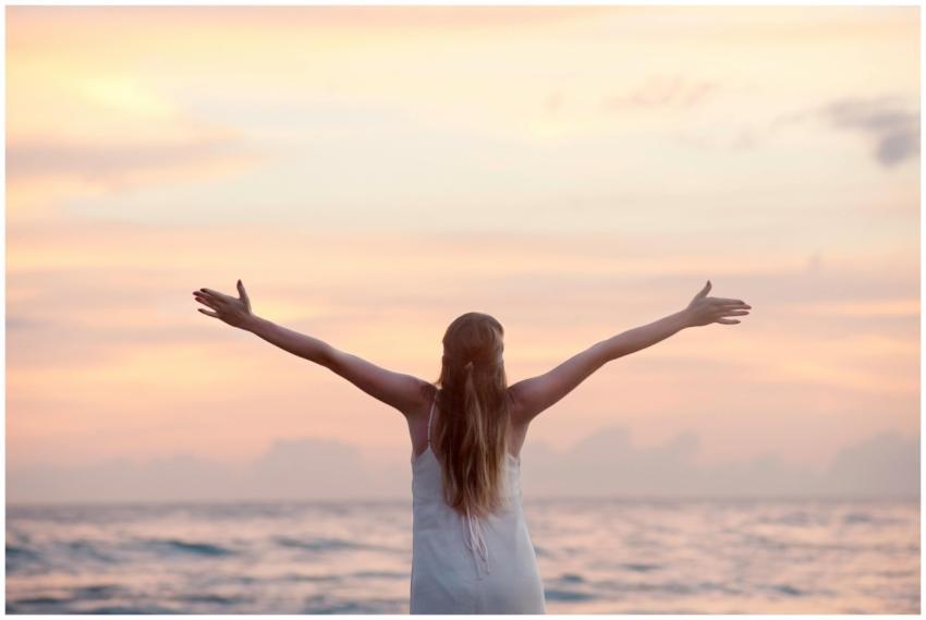 A woman enjoying a serene sunset on Unawatuna Beac