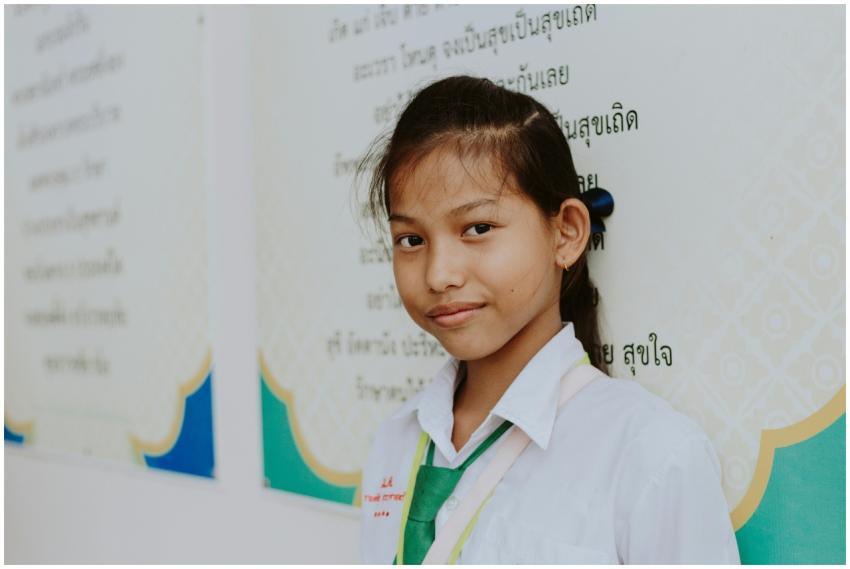 Portrait of a young Thai schoolgirl in uniform smi