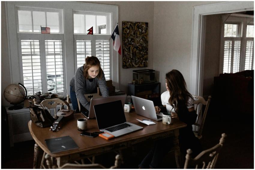 Two young women working collaboratively in a cozy