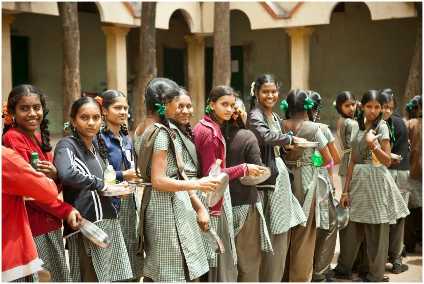 Group of smiling schoolgirls with braids standing