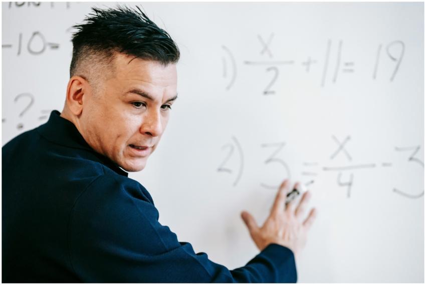 A mathematics instructor explaining algebraic equa