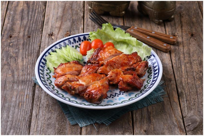 Juicy grilled chicken on a rustic plate with fresh