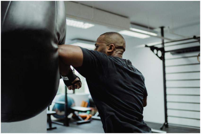 Intense moment of a boxer hitting a punching bag d