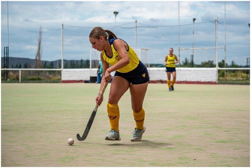 Female athlete playing field hockey outdoors on a