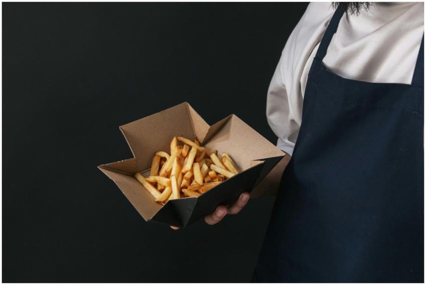 Tasty french fries served in a cardboard container