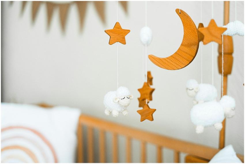 Wooden crib mobile featuring stars, a crescent moo