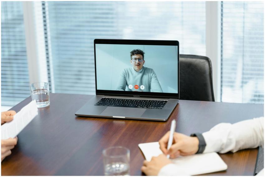 A professional setting with a virtual meeting on a