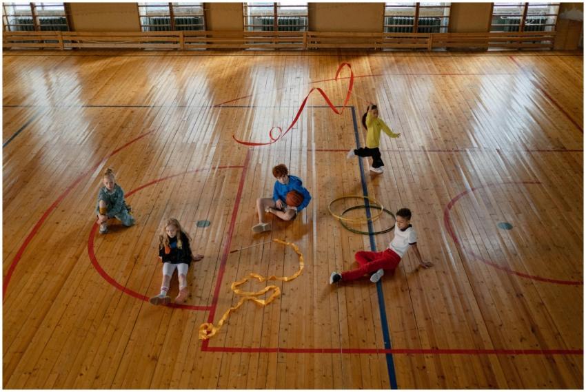 Children playing various games in an indoor gym wi