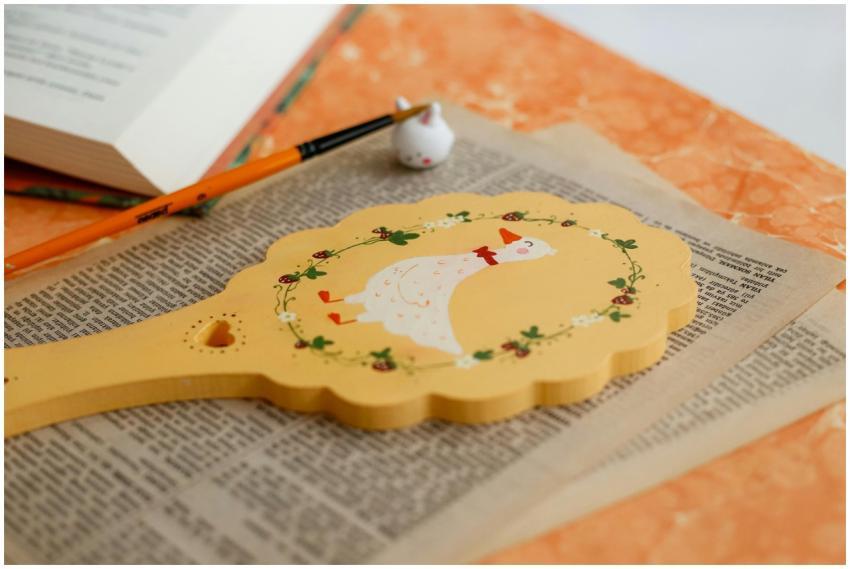 Charming vintage wooden token with duck illustrati