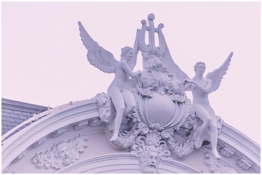 Ornate angelic sculptures on historic building fac