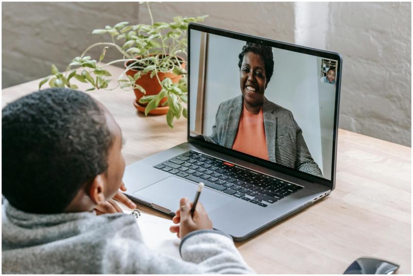 A child participates in online tutoring, focusing