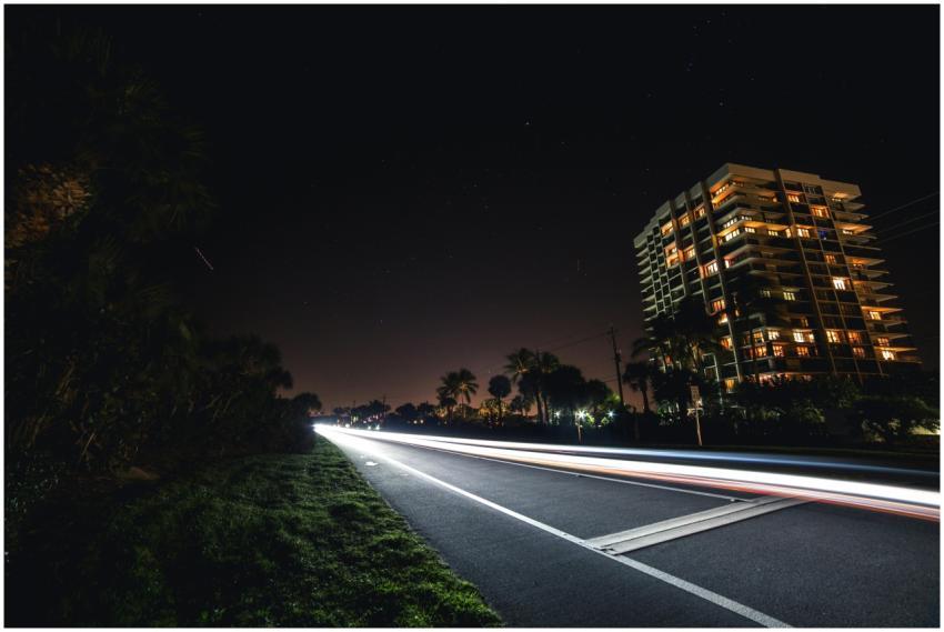 Night view of a city road with moving lights and a