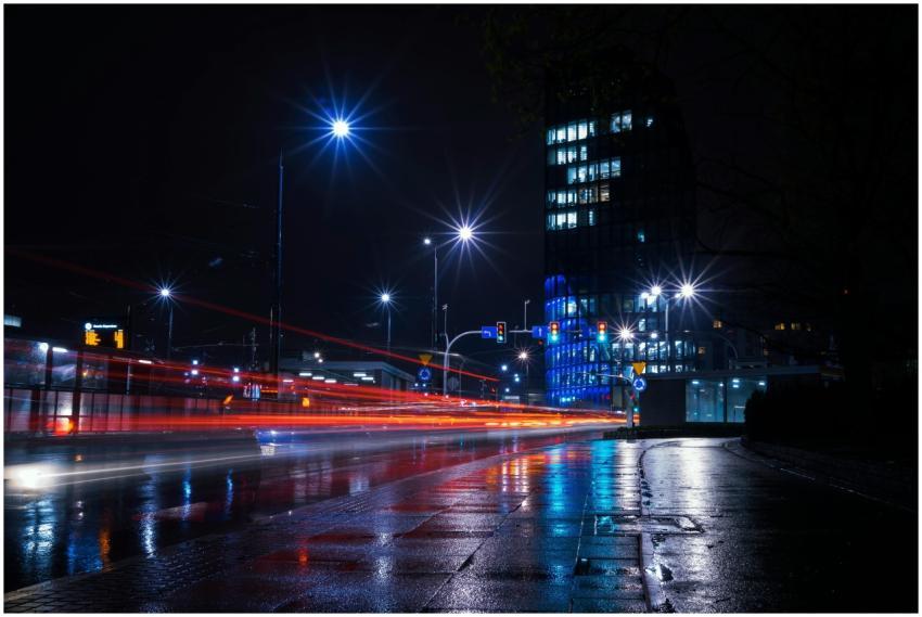 Illuminated city street at night with vibrant ligh