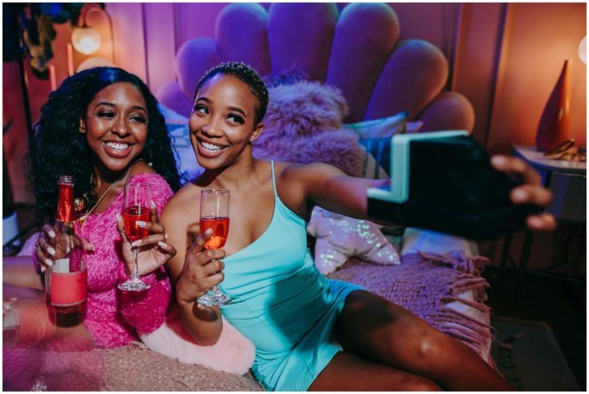 Two young women enjoying a festive indoor celebrat