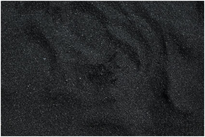Close-up of black sand texture from Waimea Beach i