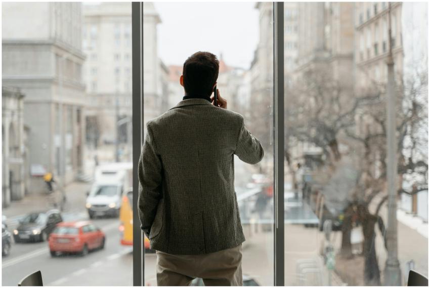 A businessman on a phone call, standing next to a