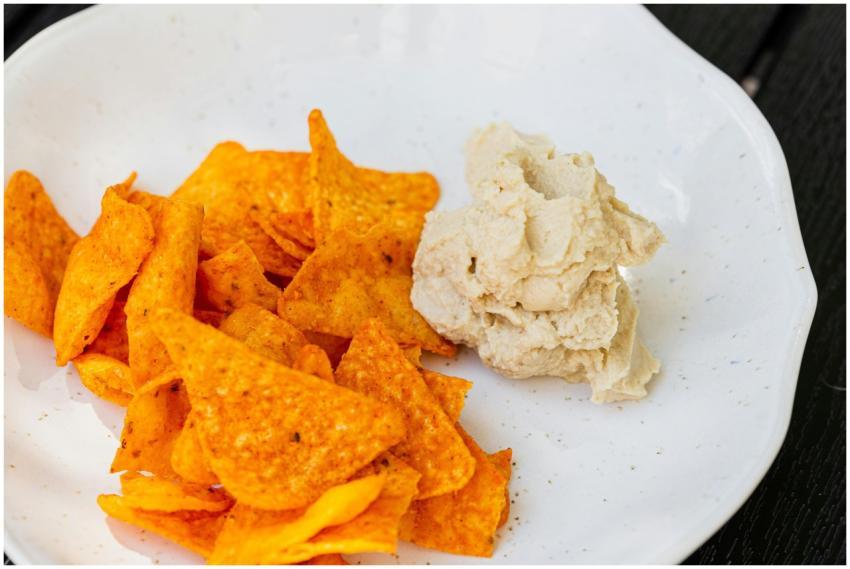 A close-up shot of spicy nachos served with creamy