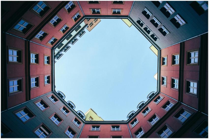 Upward view of symmetrical urban buildings showcas