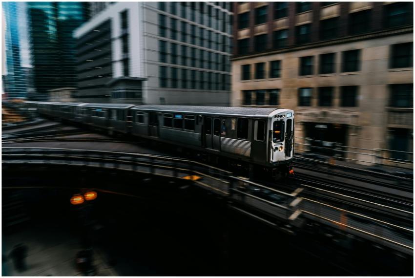 Fast-moving train on elevated tracks amidst downto