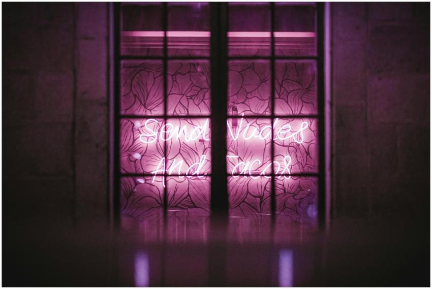 Bright pink neon lighting behind a decorative wind