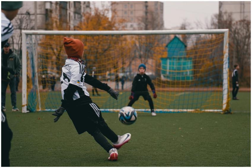 Children playing soccer on a cool autumn day in a