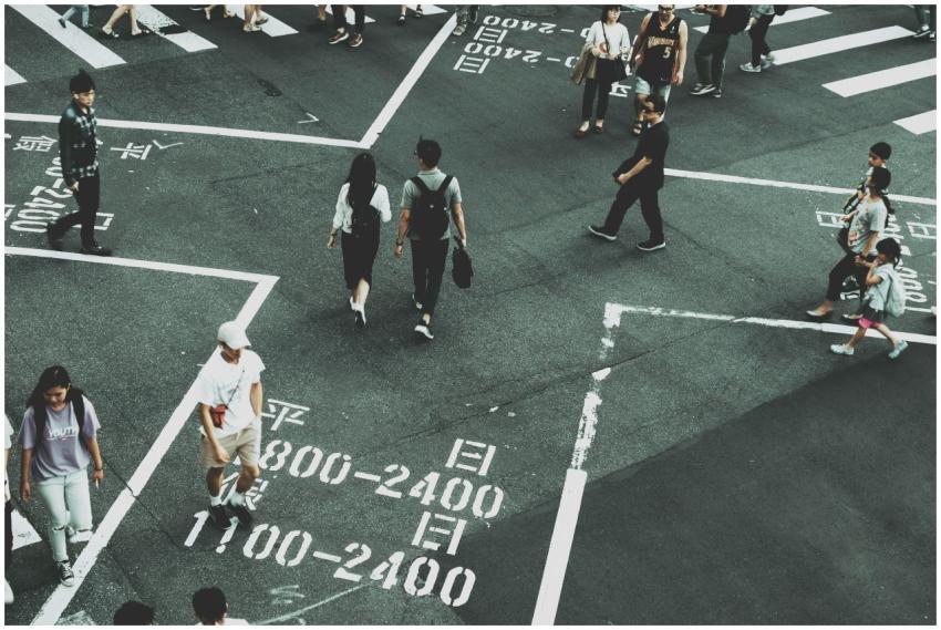 Aerial view of people crossing a busy intersection