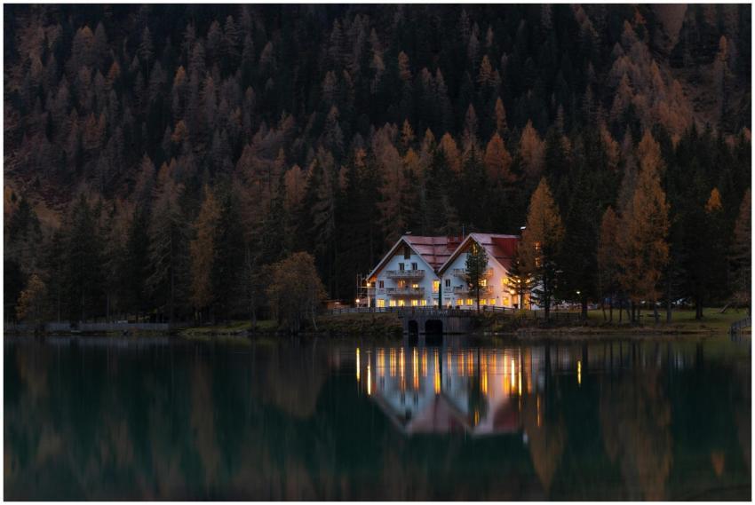 Scenic autumn view of a lakeside house reflecting