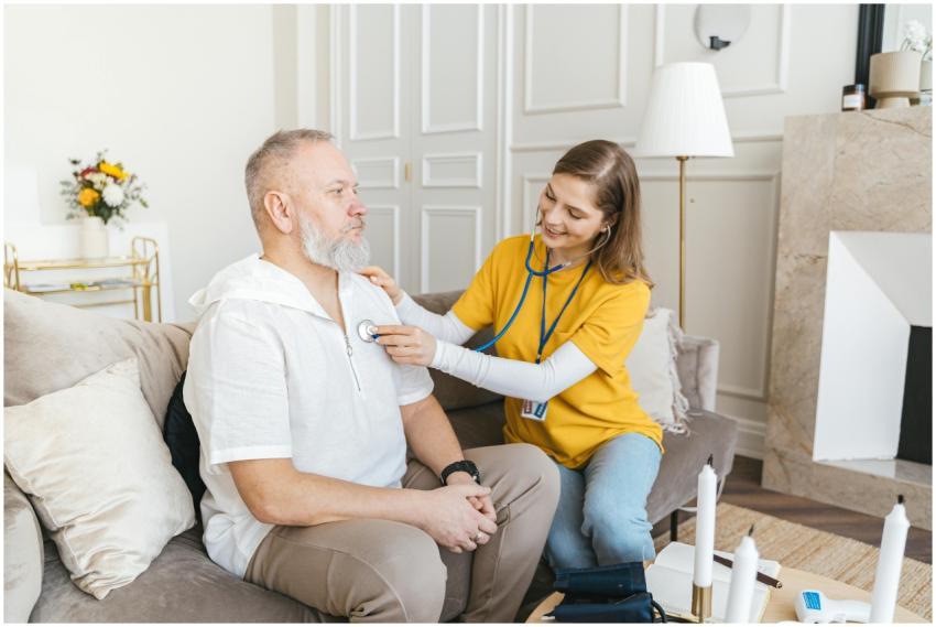 A nurse uses a stethoscope for a home check-up on
