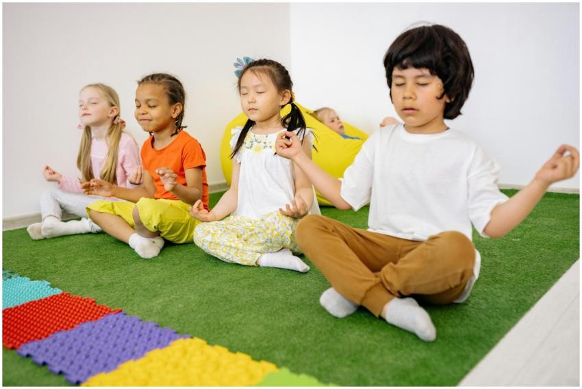 Group of diverse young children meditating in yoga