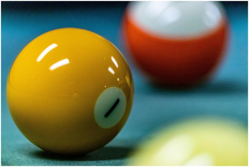 Vibrant close-up of yellow billiard ball with blur