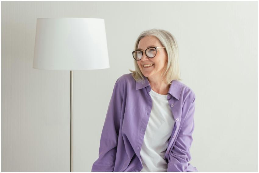 A joyful senior woman wearing eyeglasses and a pur