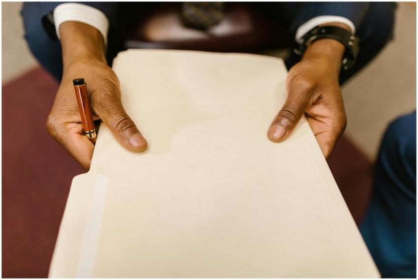 A business professional with a suit holding a lega