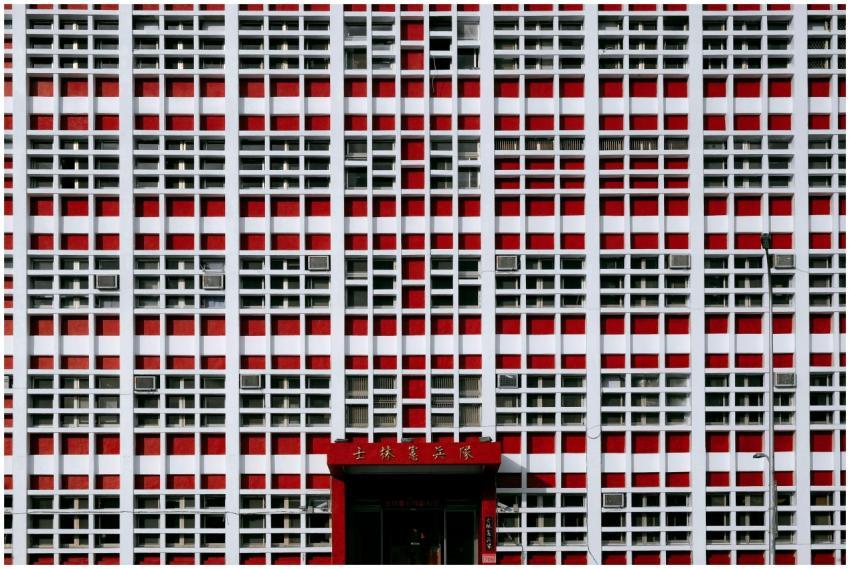 A striking red and white geometric facade of a bui