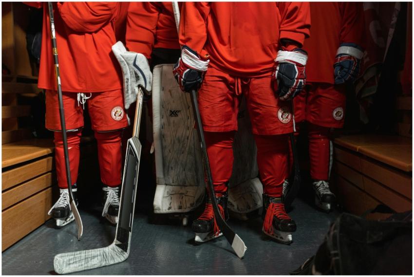 Close-up of hockey players in a locker room, ready