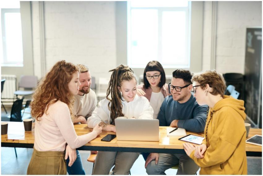 A diverse team of professionals collaborates happi