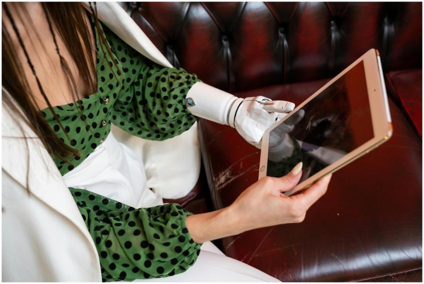A woman using her prosthetic hand to interact with